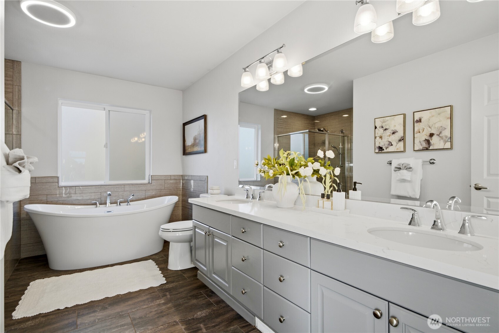 1611 242nd Street Southeast Bothell, WA 98021 - Photo 21 of 39 a spacious bathroom with a double vanity sink mirror and bathtub