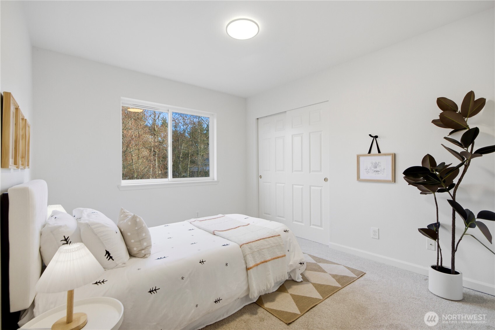 1611 242nd Street Southeast Bothell, WA 98021 - Photo 25 of 39 a bedroom with a bed and a chandelier
