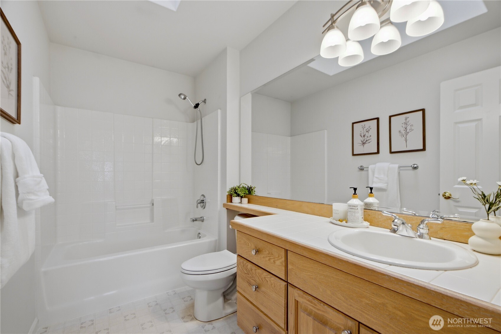 1611 242nd Street Southeast Bothell, WA 98021 - Photo 29 of 39 a bathroom with a sink a toilet a tub and a mirror