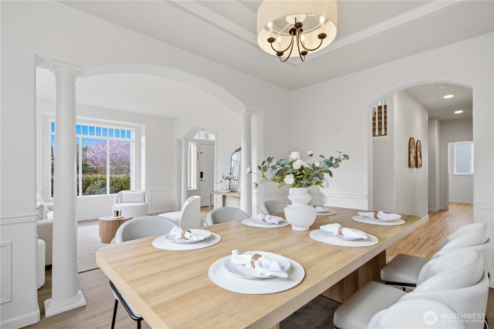 1611 242nd Street Southeast Bothell, WA 98021 - Photo 9 of 39 a view of a dining room with furniture a chandelier and wooden floor