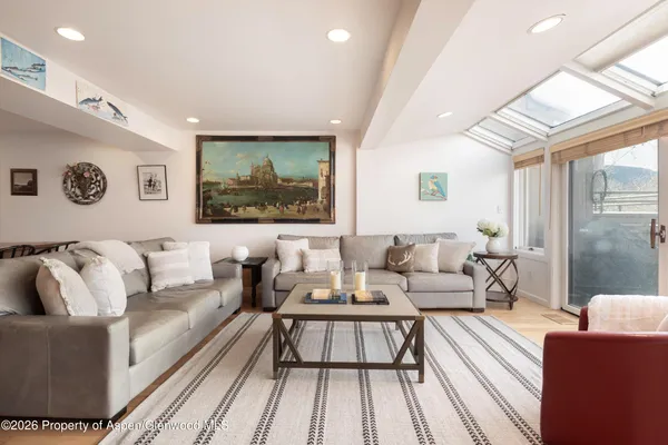 a living room with furniture wooden floor and a flat screen tv
