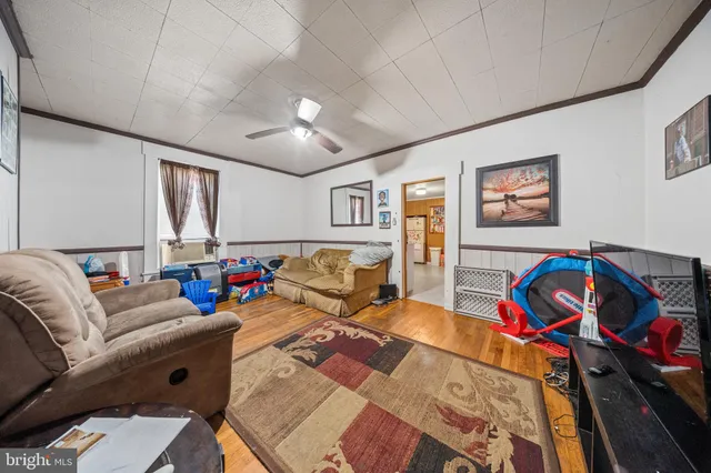 a view of living room with furniture and refrigerator