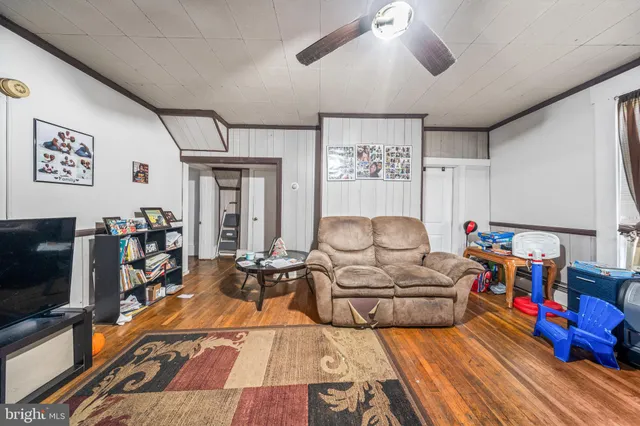 a room with furniture a rug and white walls