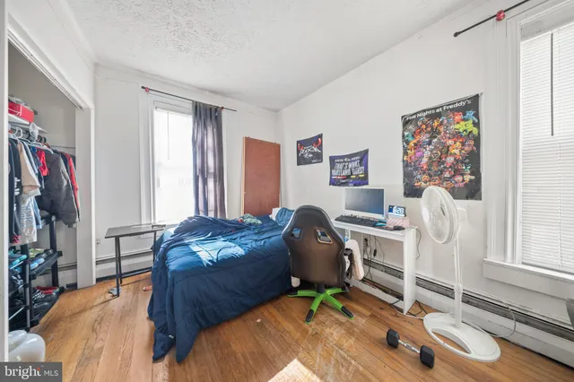 a view of a house with backyard and a tree