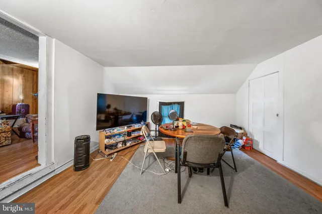 a bedroom with bed and a large window