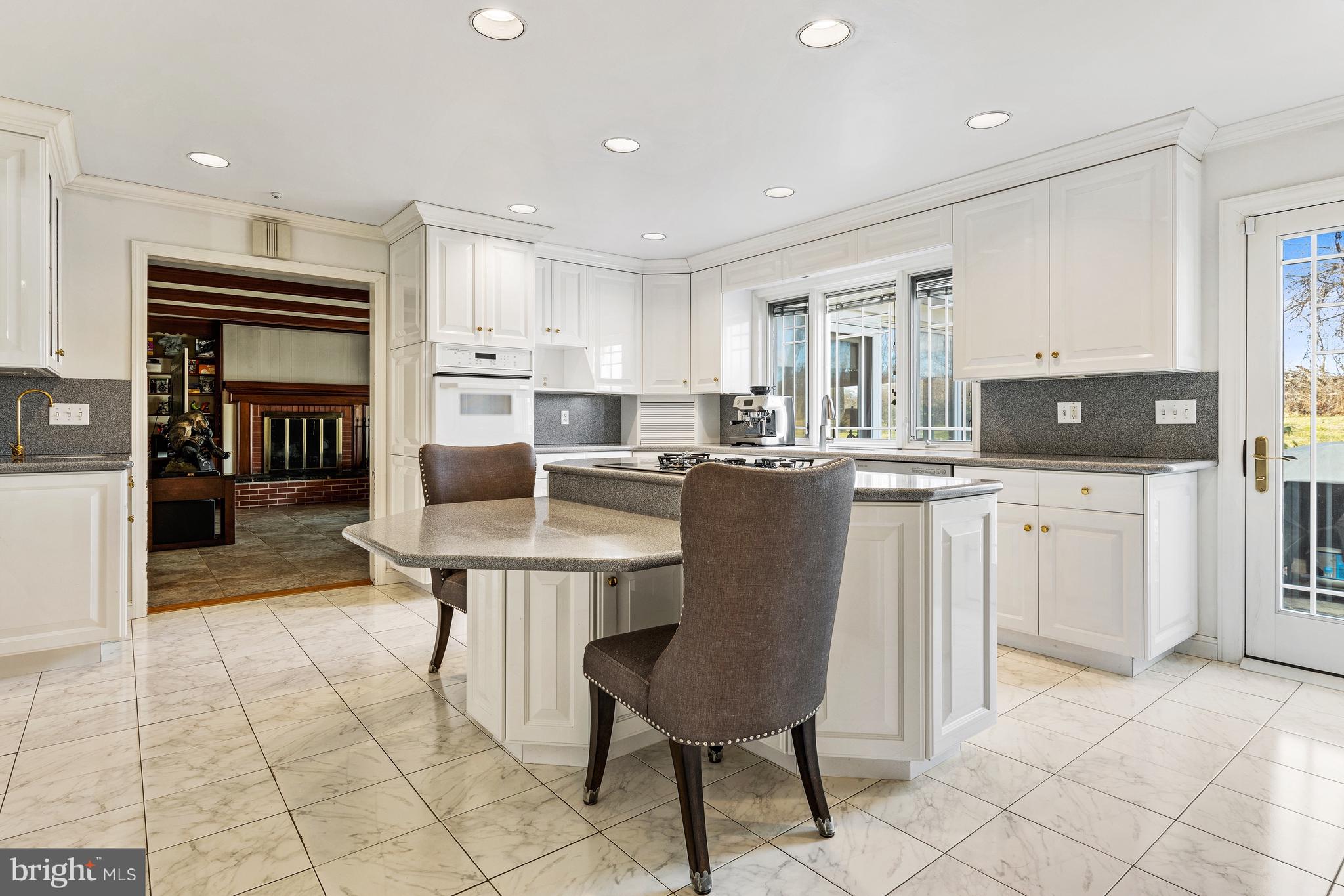 5004 Kennett Pike Wilmington, DE 19807 - Photo 13 of 37 a living room with stainless steel appliances kitchen island granite countertop a table chairs sink and cabinets