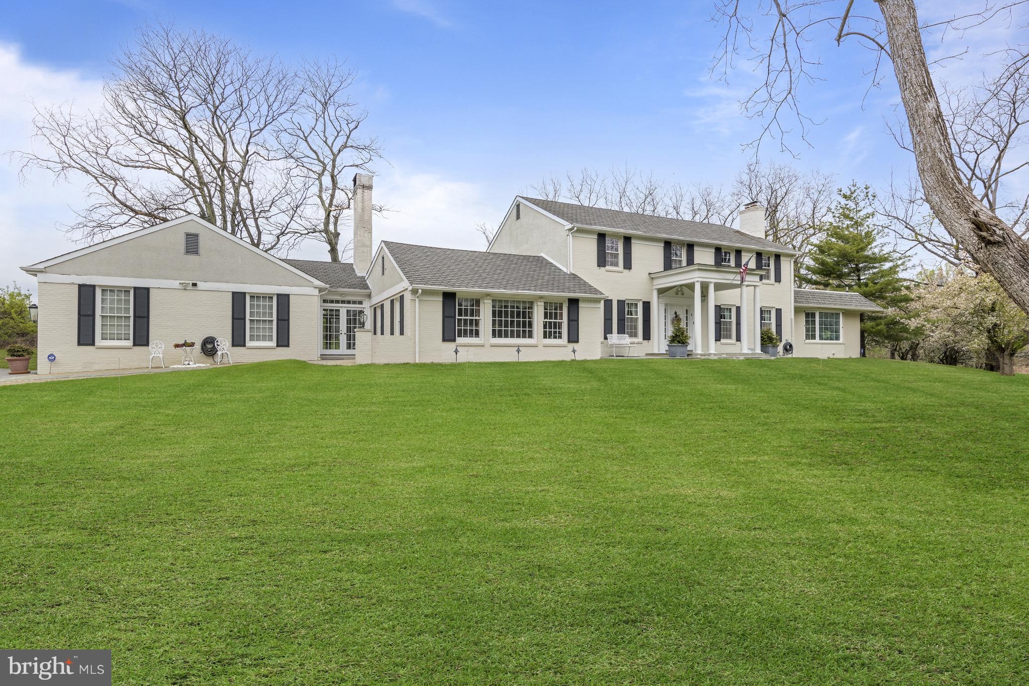 5004 Kennett Pike Wilmington, DE 19807 - Photo 3 of 37 a front view of a house with a garden and trees
