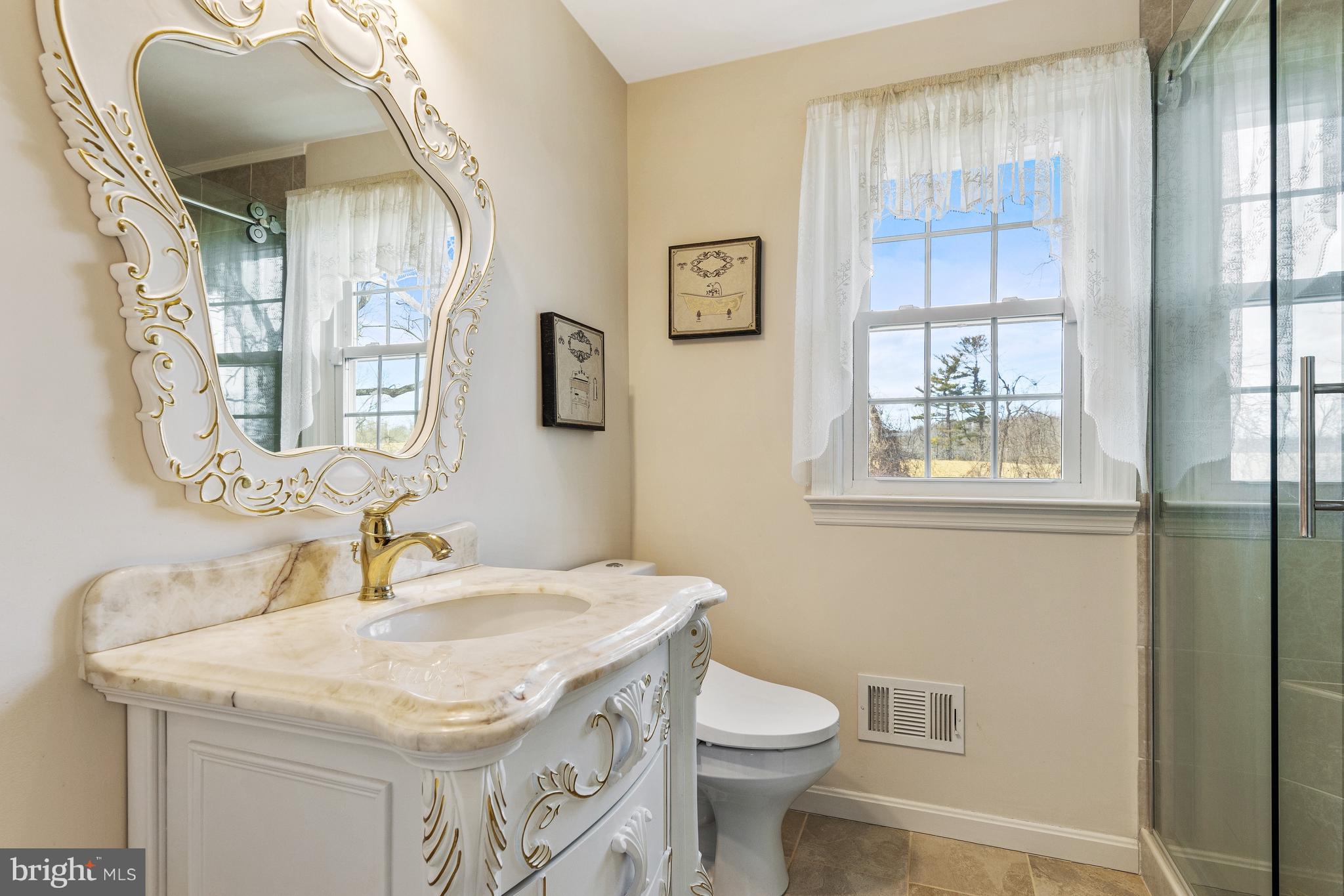 5004 Kennett Pike Wilmington, DE 19807 - Photo 31 of 37 a bathroom with a sink and a mirror
