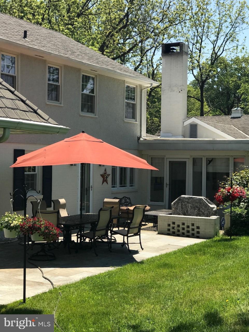 5004 Kennett Pike Wilmington, DE 19807 - Photo 32 of 37 a patio with a table and chairs under an umbrella