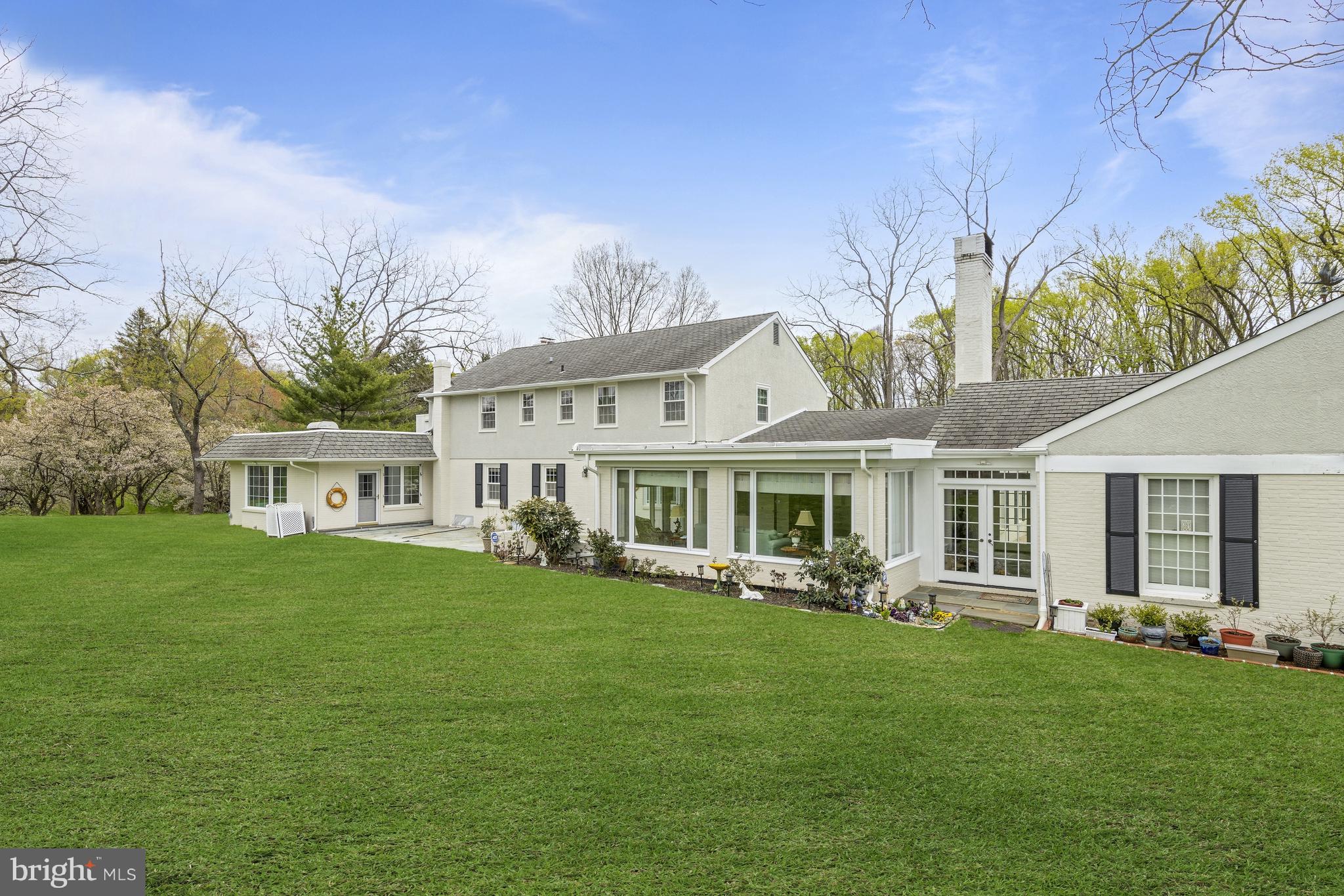 5004 Kennett Pike Wilmington, DE 19807 - Photo 36 of 37 a front view of a house with a garden and trees
