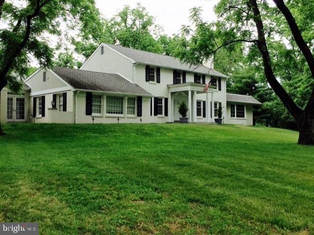 5004 Kennett Pike Wilmington, DE 19807 - Photo 5 of 37 a front view of a house with a garden