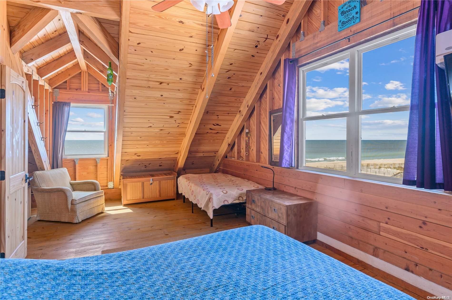 39 Seneca Street Ocean Beach, NY 11770 - Photo 15 of 26 a living room with furniture and a rug