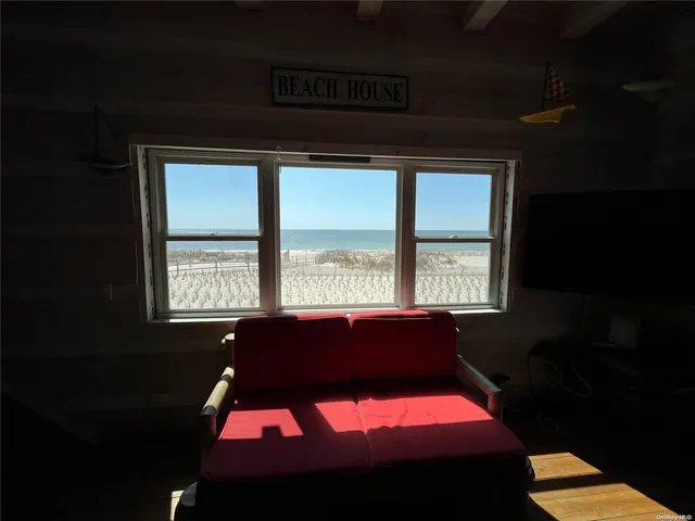 a room with pool table and windows
