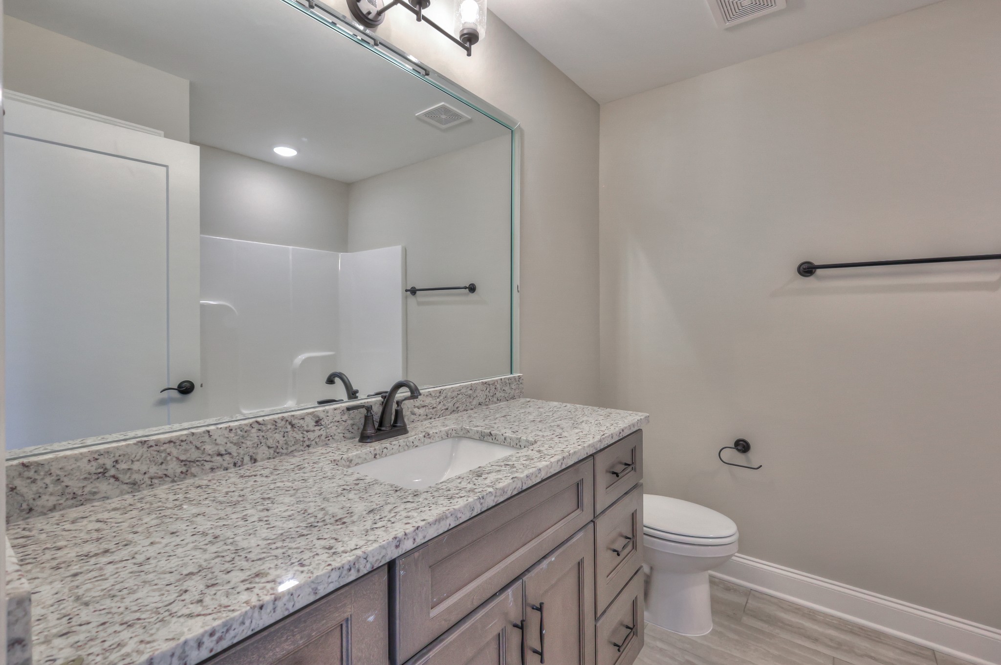 1875 Templow Road Bethpage, TN 37022 - Photo 18 of 49 a bathroom with a granite countertop sink a toilet and a mirror