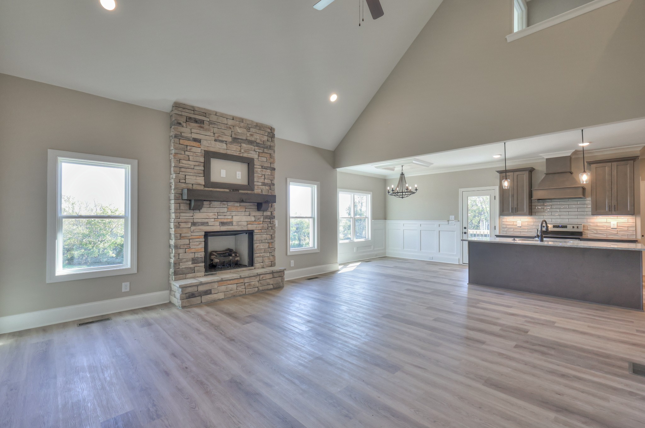 1875 Templow Road Bethpage, TN 37022 - Photo 29 of 49 an empty room with wooden floor a fireplace and windows
