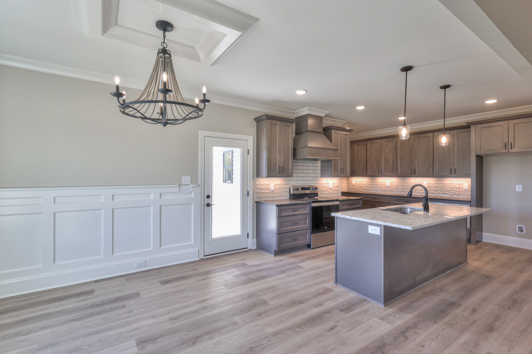 1875 Templow Road Bethpage, TN 37022 - Photo 31 of 49 a large kitchen with stainless steel appliances granite countertop a sink a stove and a wooden floors