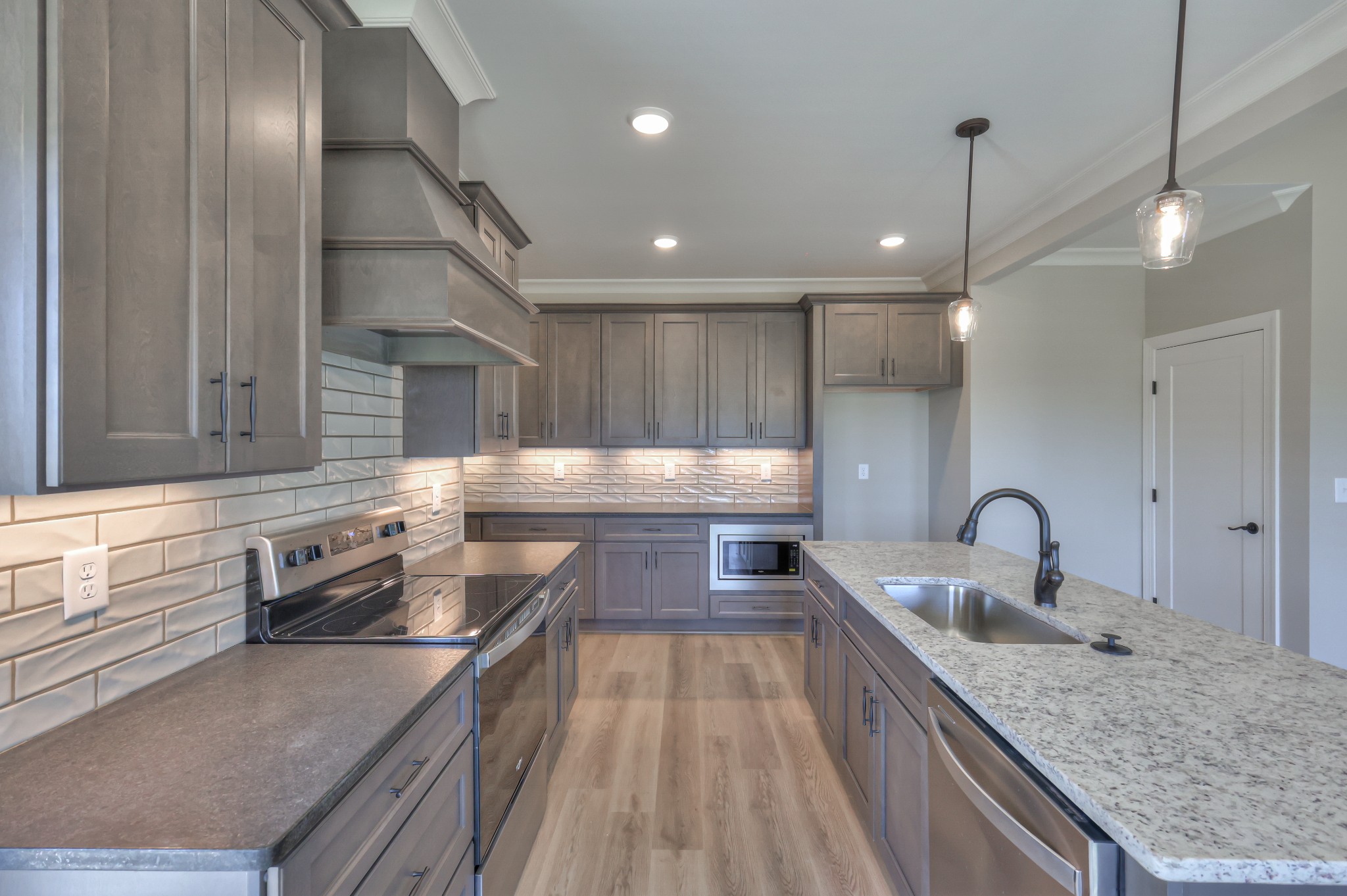 1875 Templow Road Bethpage, TN 37022 - Photo 33 of 49 a kitchen with stainless steel appliances granite countertop a sink a stove and a wooden cabinets