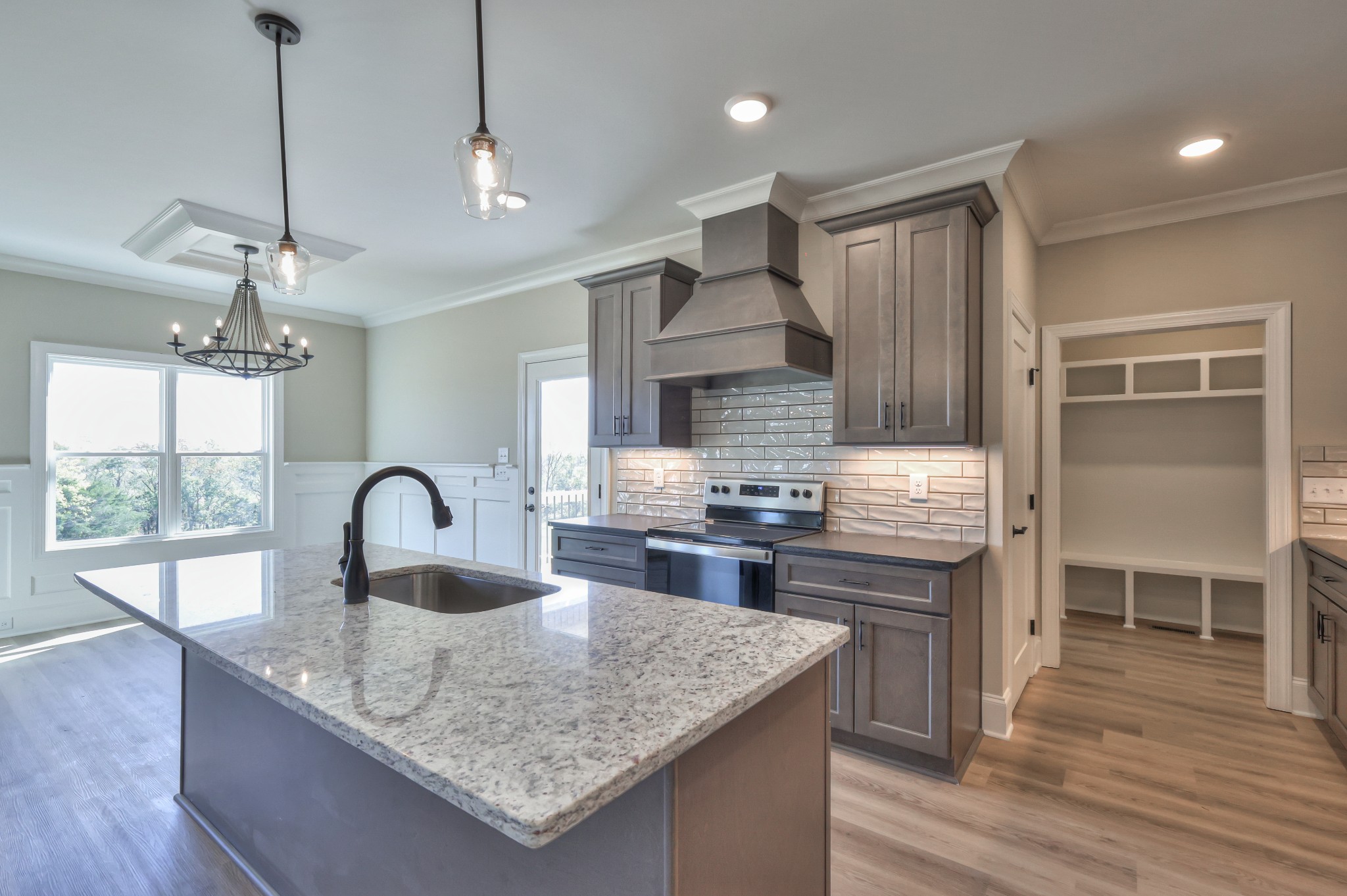 1875 Templow Road Bethpage, TN 37022 - Photo 35 of 49 a kitchen with kitchen island a large counter appliances a sink cabinets and wooden floor