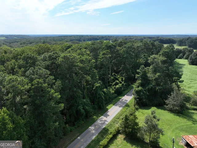 an aerial view of a houses with a yard