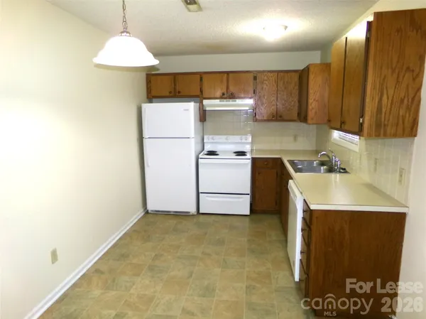 a kitchen with a sink a stove and a refrigerator