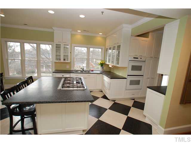 1612 Oberlin Road, Unit 5 Raleigh, NC 27608 - Photo 11 of 25 a kitchen with a stove a sink and a refrigerator