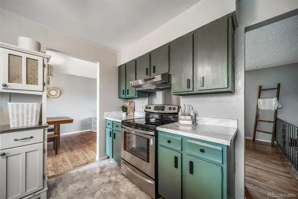 a kitchen with stainless steel appliances granite countertop a sink stove and cabinets