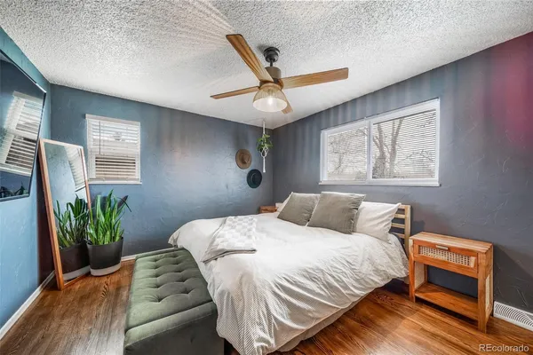 a bedroom with a bed and a potted plant