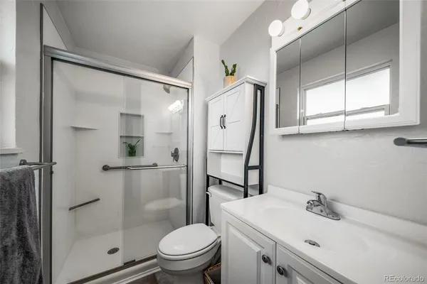 a bathroom with a sink toilet and shower