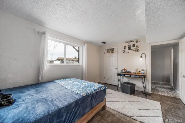 a bedroom with a bed dresser and a window