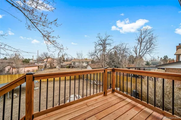 a view of a balcony with wooden fence