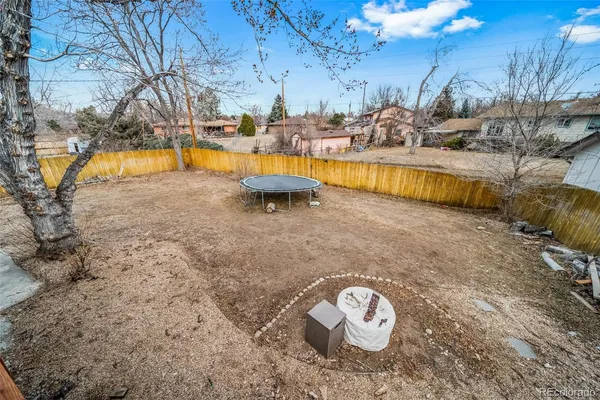 a view of a backyard with swimming pool