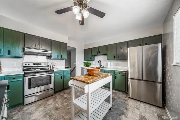 a kitchen with stainless steel appliances granite countertop a stove a refrigerator and a refrigerator