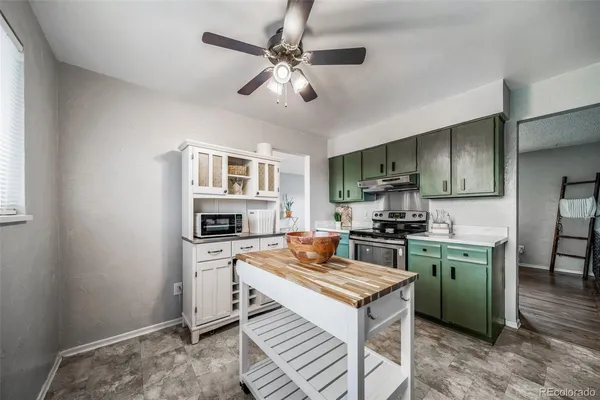 a kitchen with a stove a sink and a microwave