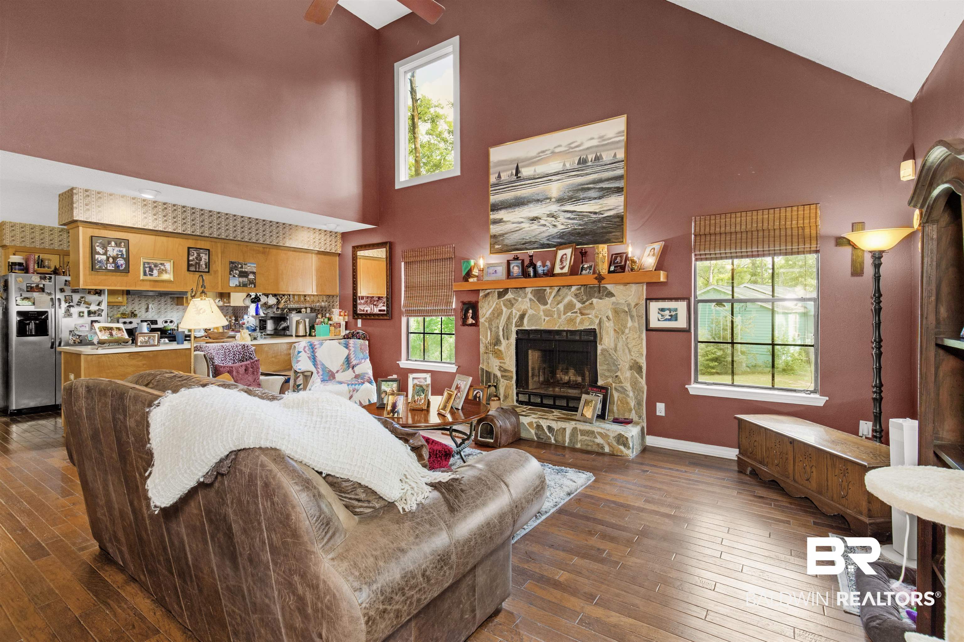 31375 Stagecoach Road Daphne, AL 36527 - Photo 4 of 21 Living room with high vaulted ceiling, hardwood / wood-style flooring, a fireplace, ceiling fan, and baseboards