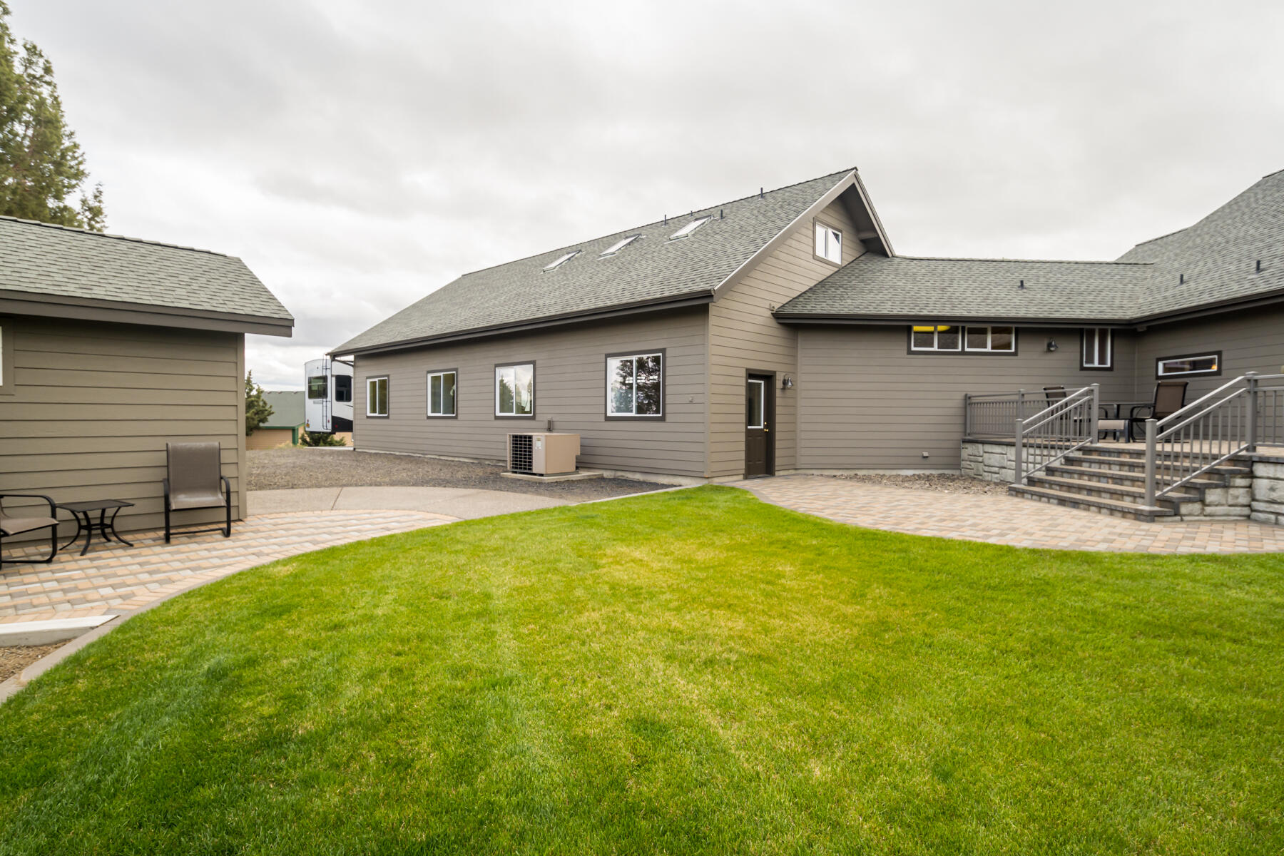 60850 Jennings Road Bend, OR 97702 - Photo 42 of 52 a front view of a house with swimming pool and chairs