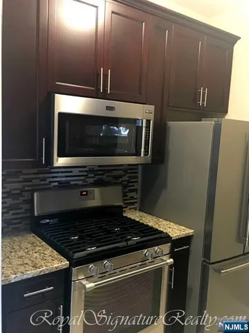 a stove top oven sitting inside of a kitchen