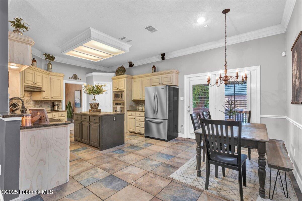 7206 76th Street Lubbock, TX 79407 - Photo 13 of 55 a kitchen with a dining table chairs stainless steel appliances and cabinets