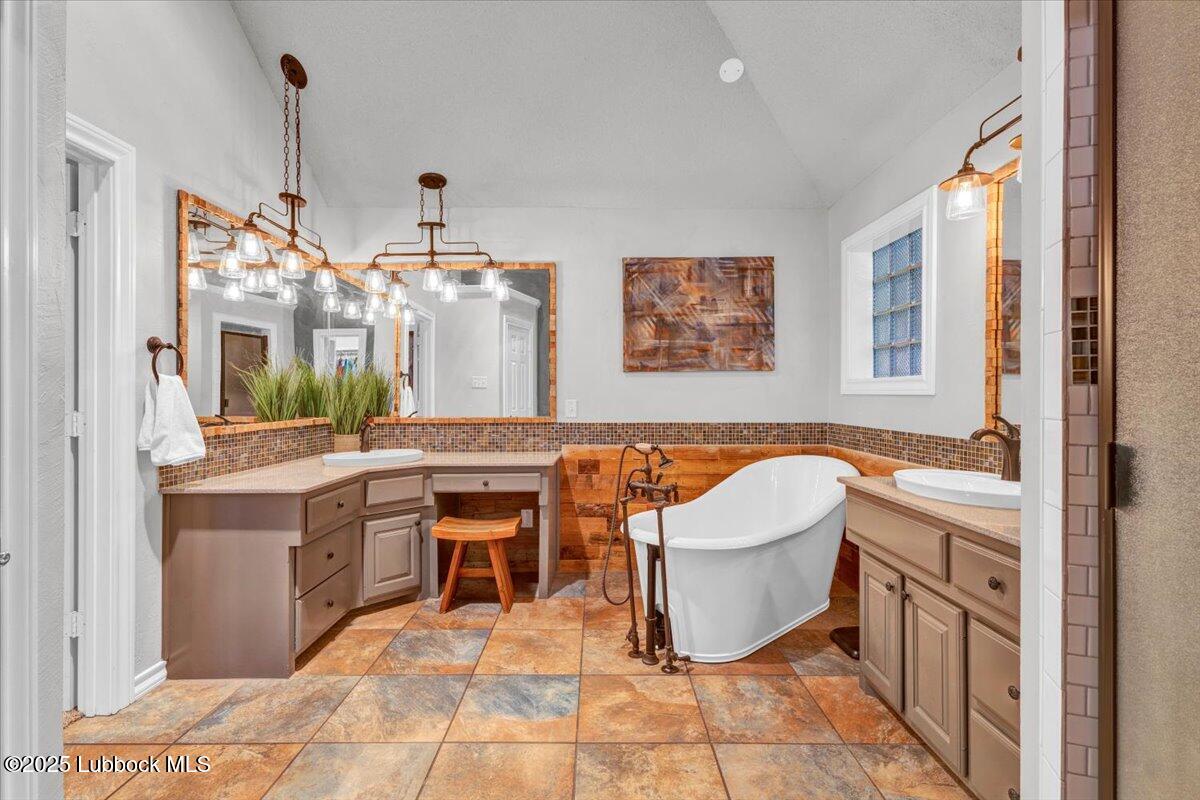 7206 76th Street Lubbock, TX 79407 - Photo 18 of 55 a spacious bathroom with a tub sink and mirror