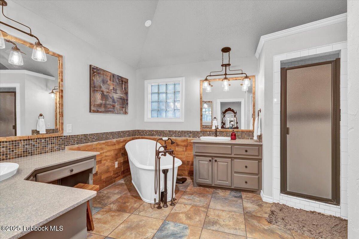 7206 76th Street Lubbock, TX 79407 - Photo 19 of 55 a spacious bathroom with a granite countertop sink a mirror and a bathtub