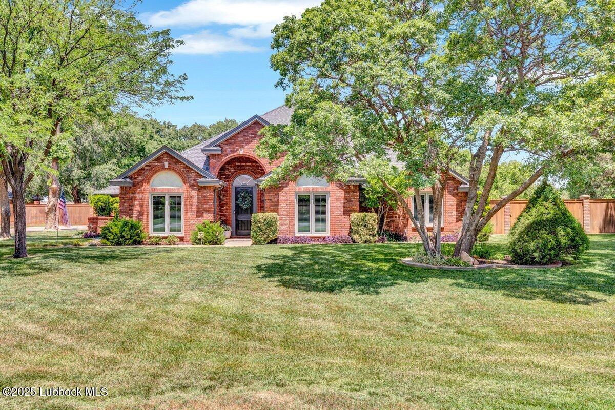 7206 76th Street Lubbock, TX 79407 - Photo 2 of 55 a front view of a house with a yard