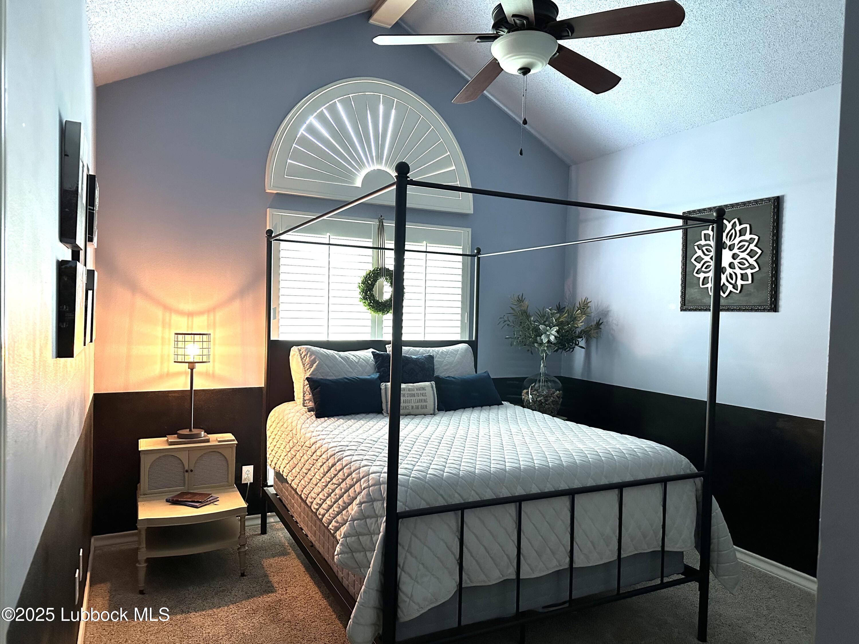 7206 76th Street Lubbock, TX 79407 - Photo 22 of 55 a bedroom with a bed and a chandelier
