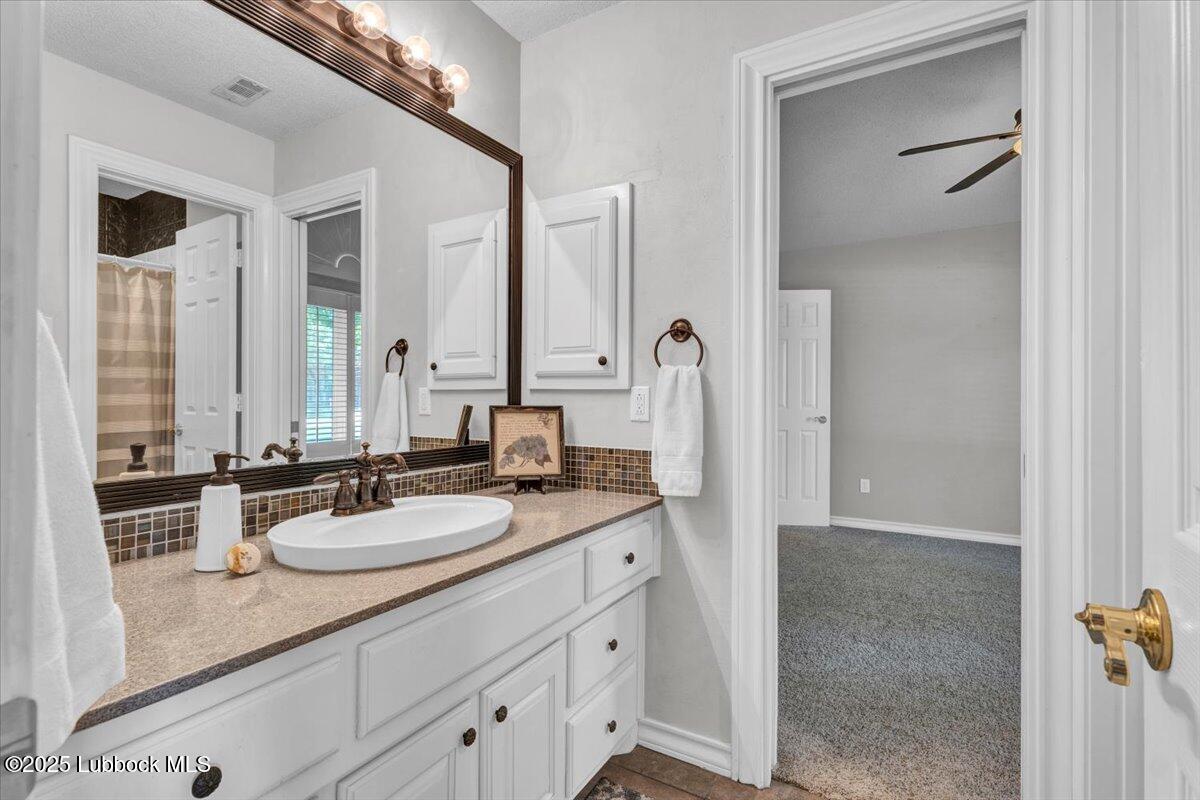 7206 76th Street Lubbock, TX 79407 - Photo 26 of 55 a bathroom with a sink double vanity and a mirror