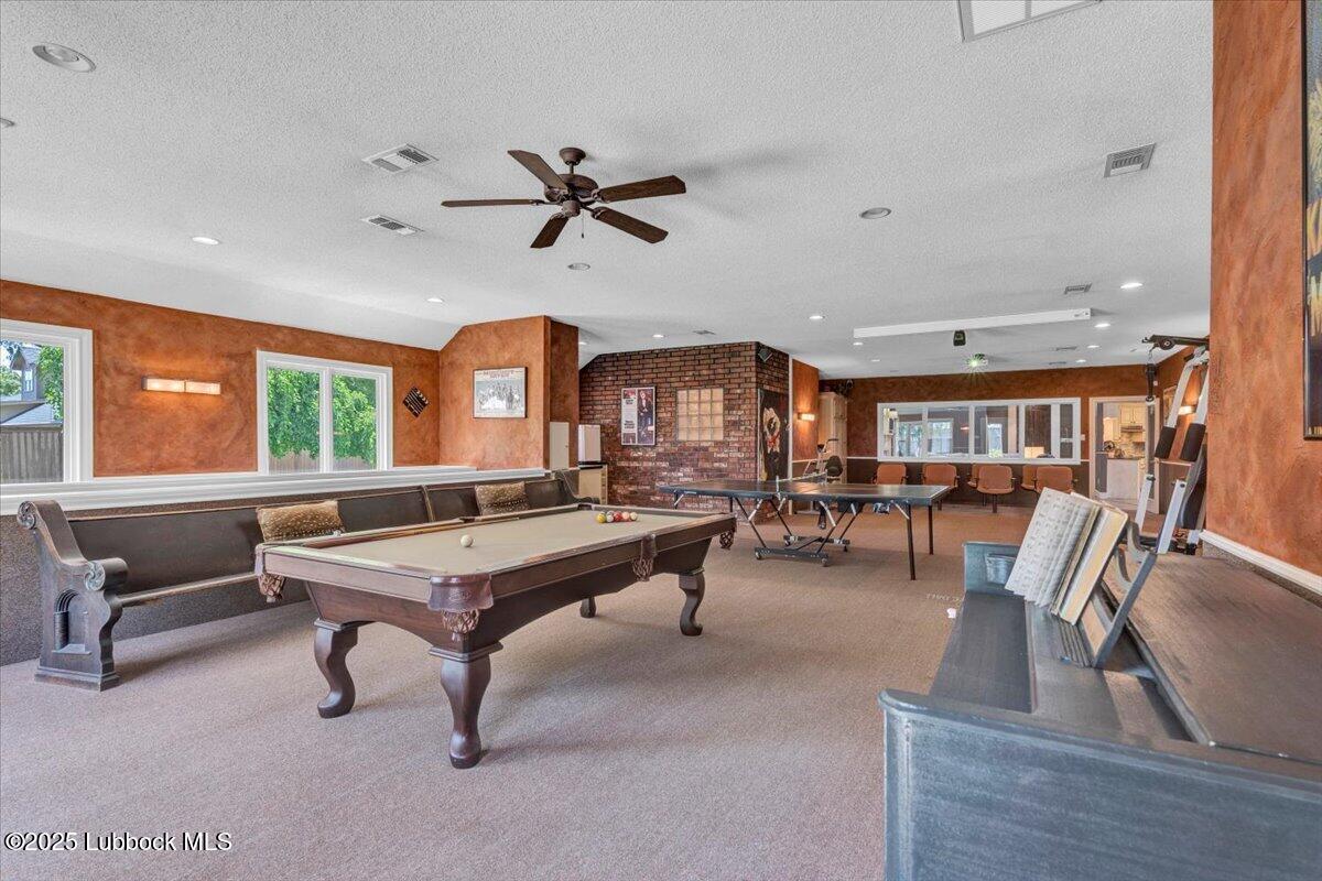 7206 76th Street Lubbock, TX 79407 - Photo 33 of 55 a living room with furniture a window and gym equipment