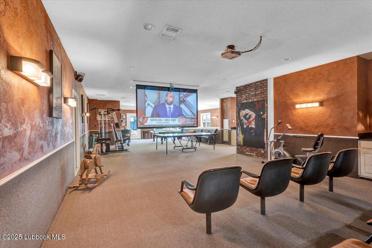 7206 76th Street Lubbock, TX 79407 - Photo 36 of 55 a living room with furniture and a flat screen tv