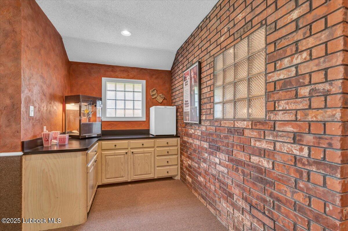 7206 76th Street Lubbock, TX 79407 - Photo 37 of 55 a kitchen with granite countertop white cabinets and white appliances