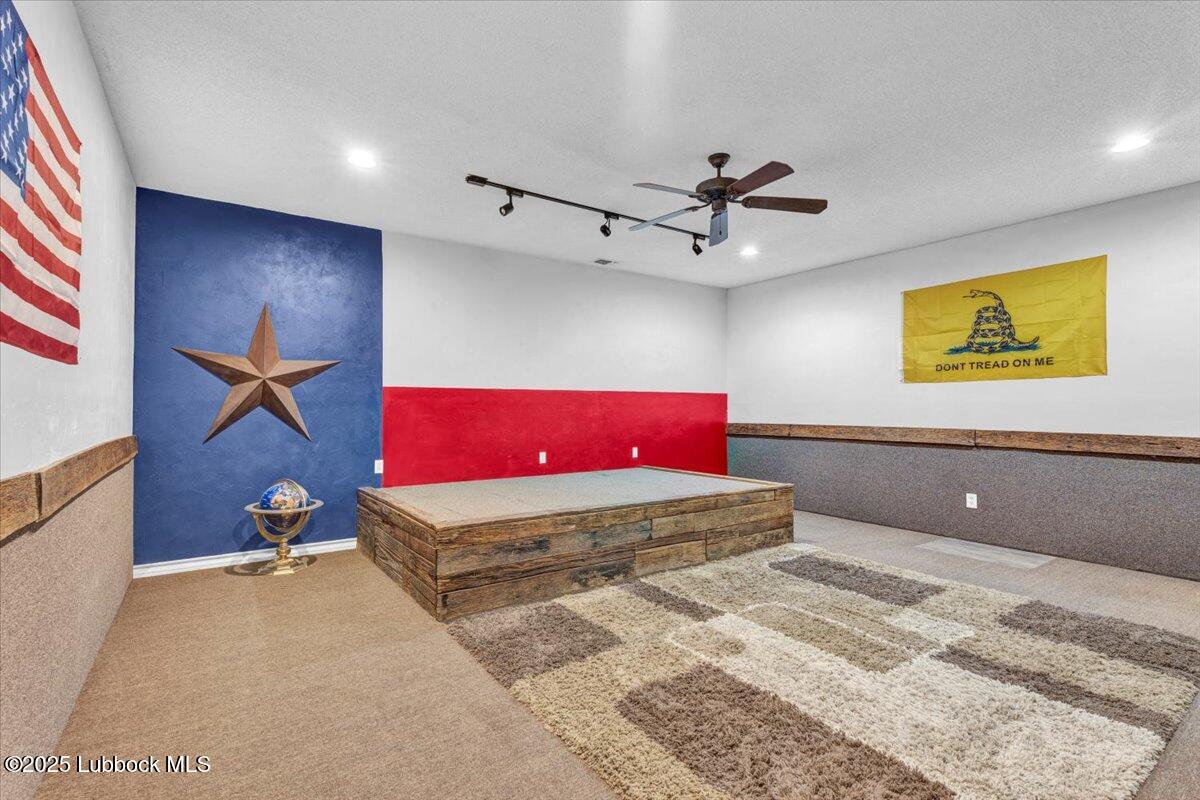 7206 76th Street Lubbock, TX 79407 - Photo 38 of 55 a bedroom with a bed and a chandelier