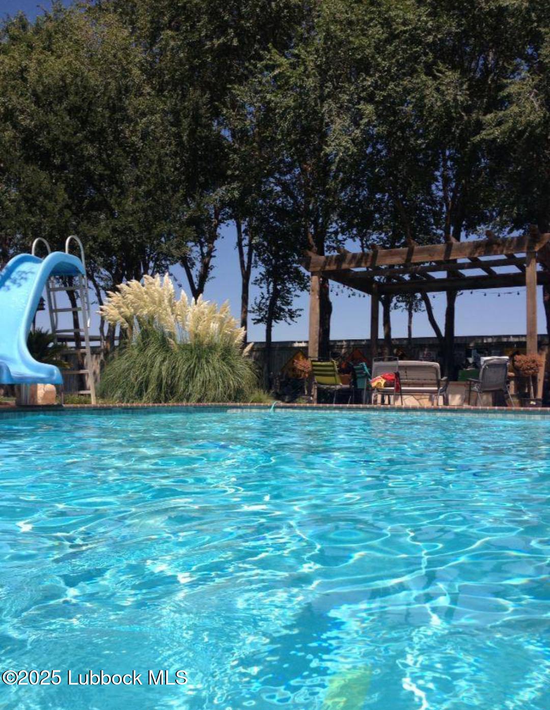 7206 76th Street Lubbock, TX 79407 - Photo 44 of 55 a front view of a house with a garden