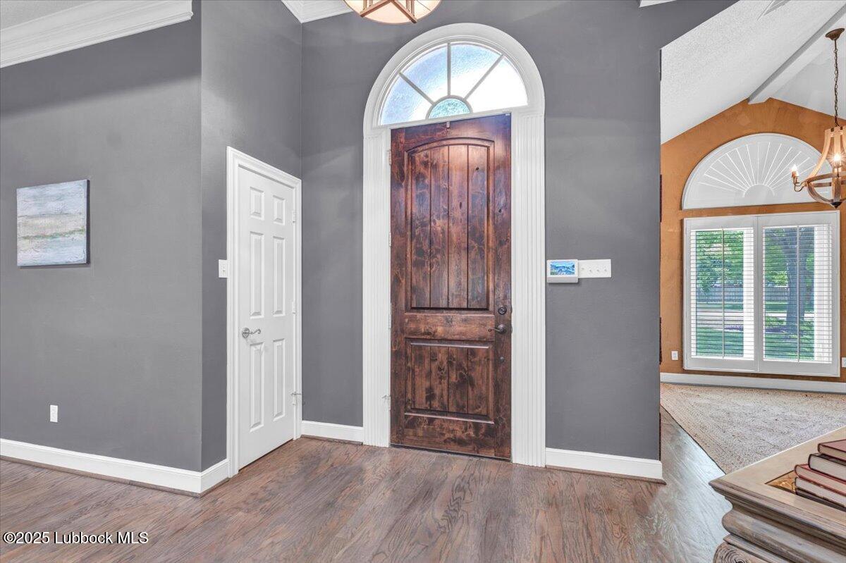7206 76th Street Lubbock, TX 79407 - Photo 5 of 55 an empty room with wooden floor closet and windows