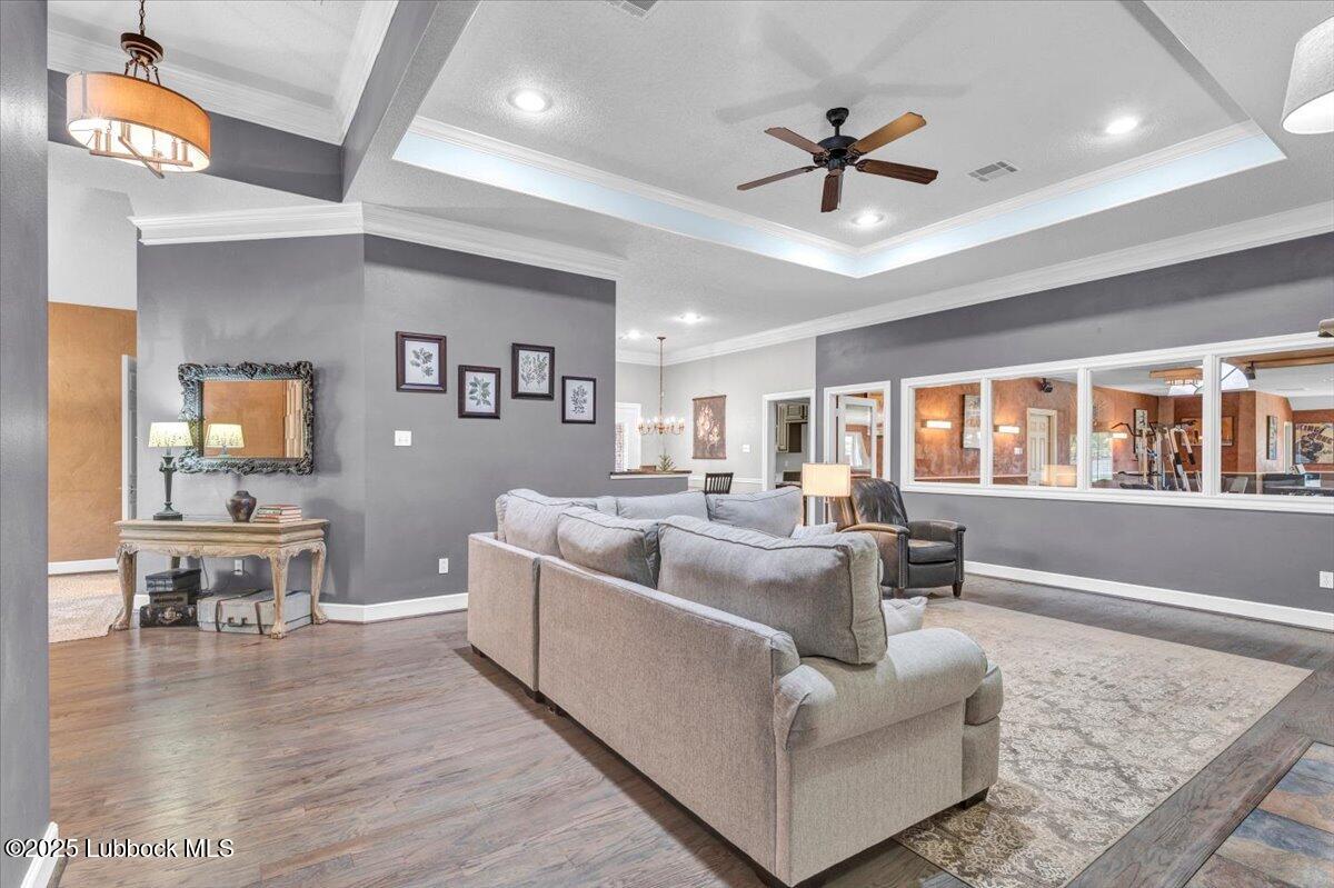 7206 76th Street Lubbock, TX 79407 - Photo 6 of 55 a living room with furniture ceiling fan and a rug