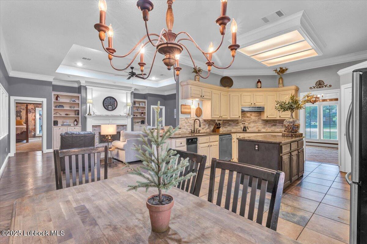 7206 76th Street Lubbock, TX 79407 - Photo 10 of 55 a kitchen with stainless steel appliances kitchen island granite countertop a table chairs and a dining table view